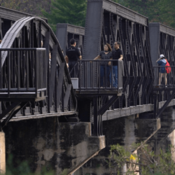 Vistors walk the famous Bridge on the River Kwai, in Kanchanaburi