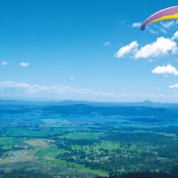 paragliding paragliding man flight mountain sky clouds land height
