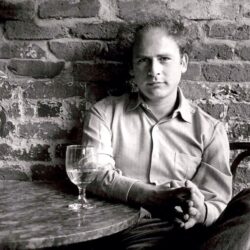 Art Garfunkel having a glass.
