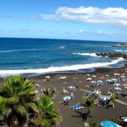 Tourism on the black beach in Tenerife wallpapers and image