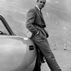 PHOTO: Actor Sean Connery poses as James Bond next to his Aston